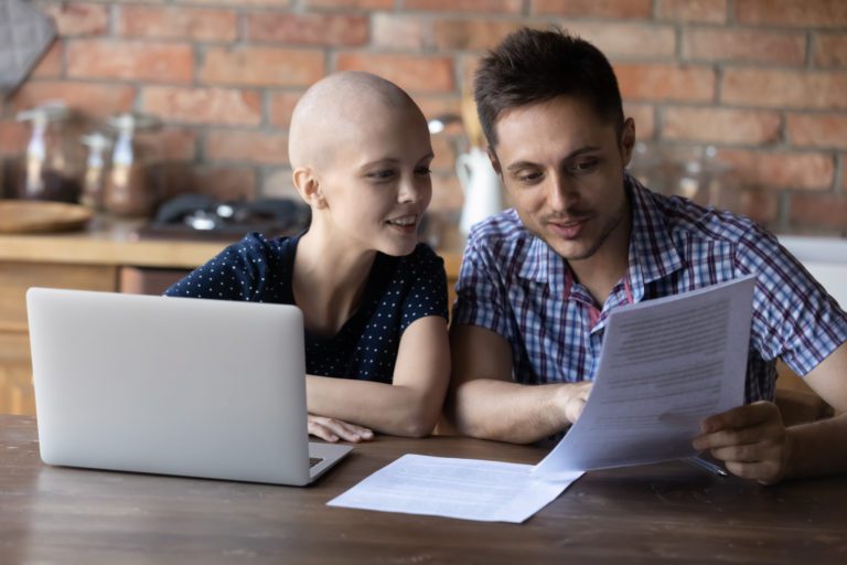 Close up happy hairless wife and husband reading good news