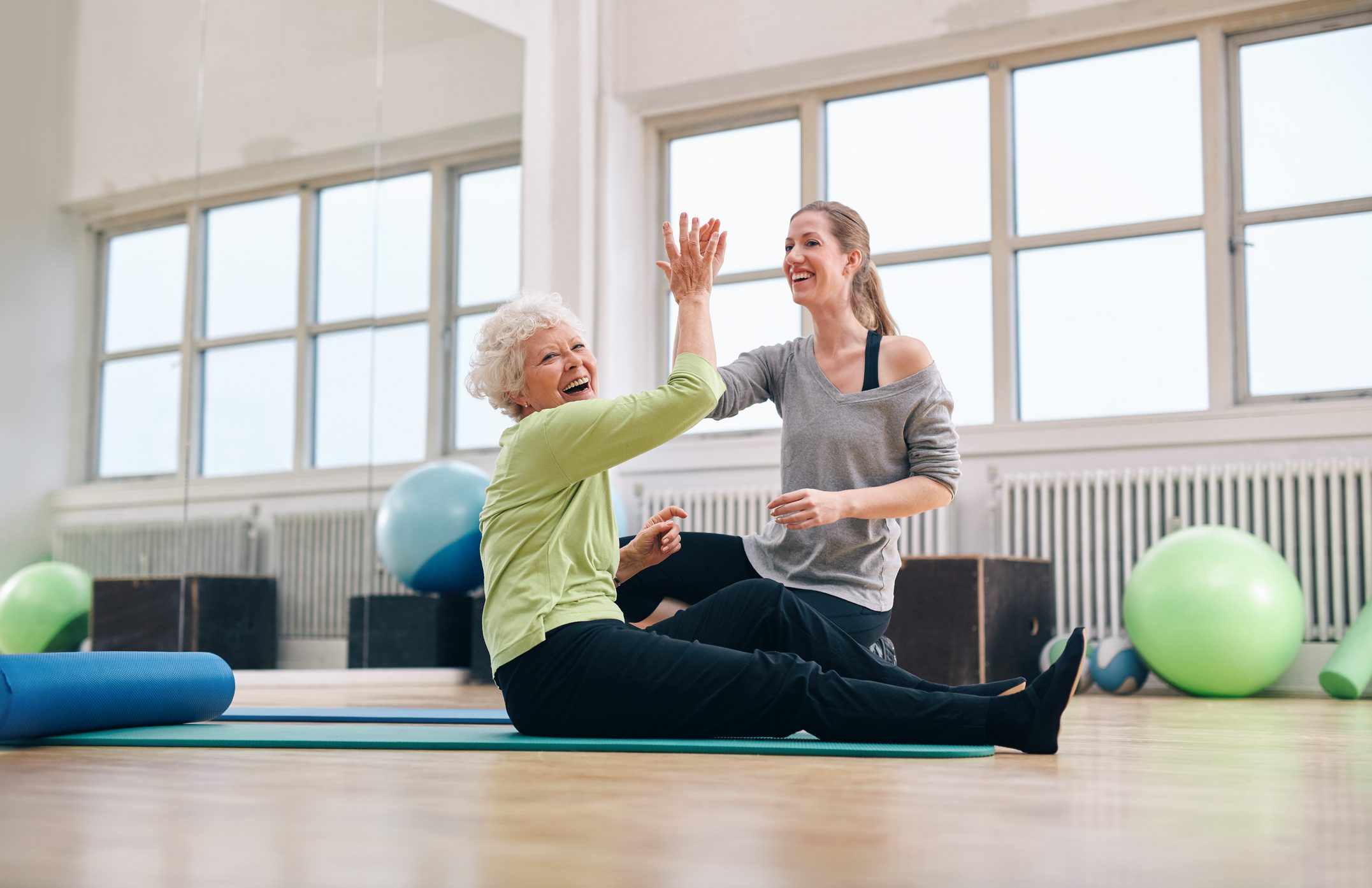 Senior woman rejoicing health success with her instructor